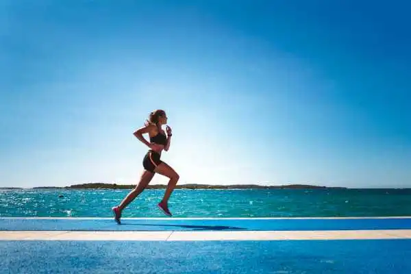 Woman running showing strong leg muscle Bradford
